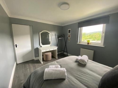 a bedroom with a large bed and a mirror at Burnt Island 2 bed apartment with stunning views in Fife