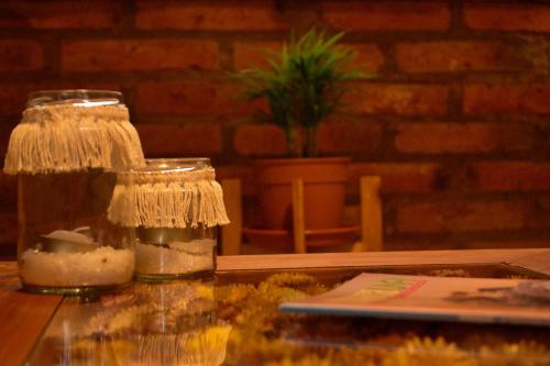 a table with two glass jars with candles on it at Cabañas Casiopea Lago Puelo in Lago Puelo