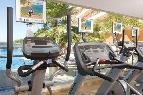 a gym with two treadmill machines and a window at Hotel Apartamento Balaia Atlantico in Albufeira