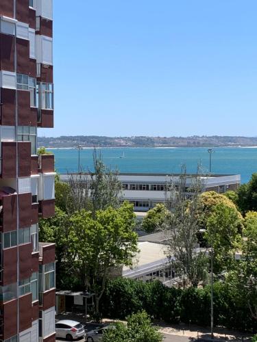 an office building with a view of the water at The apartment near the beach in Oeiras in Paço de Arcos