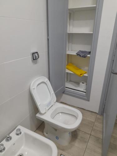 a small bathroom with a toilet and a sink at CASA CONFORTABLE II in Córdoba