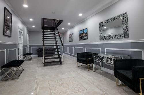 a living room with a staircase and a mirror at Niagara Luxury Suites in Niagara Falls