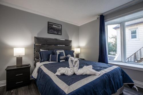 a bedroom with a large bed with towels on it at Niagara Luxury Suites in Niagara Falls