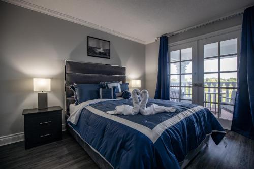 a bedroom with a bed with a pair of towels on it at Niagara Luxury Suites in Niagara Falls
