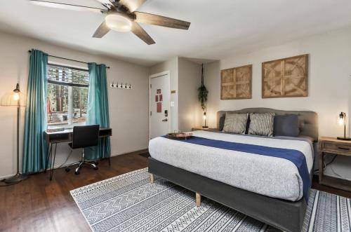 a bedroom with a bed and a desk and a window at Playpark Lodge in South Lake Tahoe