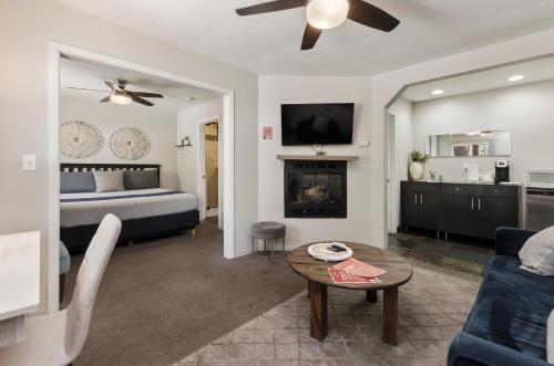 a living room with a bed and a fireplace at Playpark Lodge in South Lake Tahoe