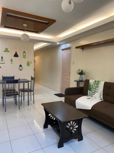 a living room with a couch and a table at One Oasis Condo 44sqm 1 Bedroom Beside SM Mall in Davao City