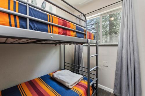 a bedroom with two bunk beds with a window at Playpark Lodge in South Lake Tahoe