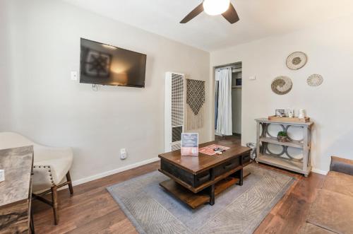 a living room with a table and a tv on the wall at Playpark Lodge in South Lake Tahoe