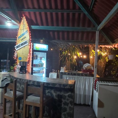 a bar in a restaurant with a table and chairs at Sweet Dreams in San Carlos