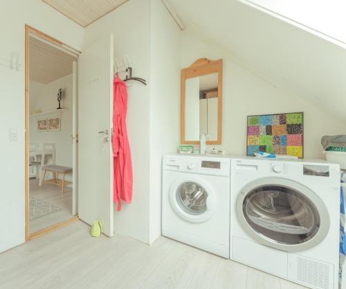 a laundry room with a washing machine and a sink at Great 3 BR Loft Apt / Views / Free Parking in Tórshavn