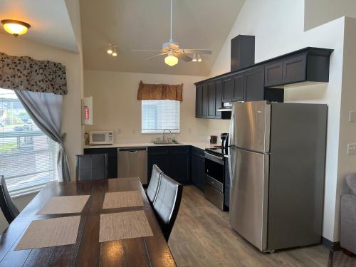 a kitchen with a table and a stainless steel refrigerator at Sunrise Inn in Anacortes