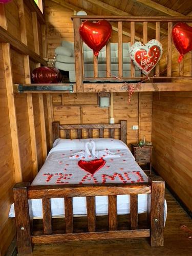 a bedroom with a bed with red hearts on it at Glamping la Kumbre - Gama in Gama