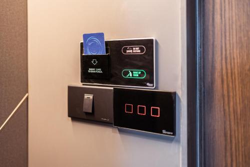 a room with a pay meter on a wall at The One Smart Living in Bangkok
