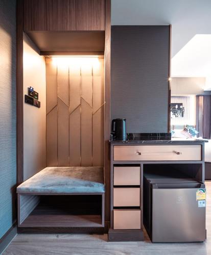 a small kitchen with a counter and a stove at The One Smart Living in Bangkok