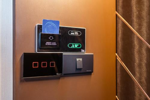 a ticket machine on a door of a hotel room at The One Smart Living in Bangkok