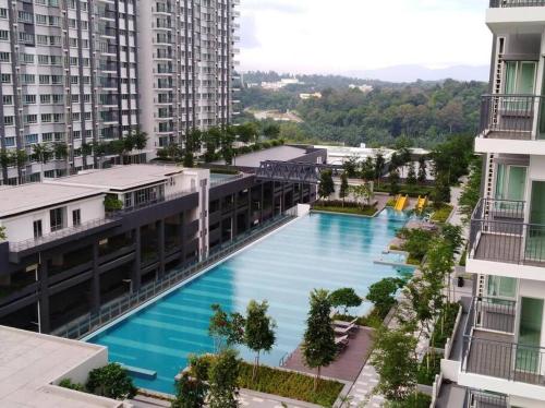 an aerial view of a pool in a city with buildings at Villa Selatan Southville City in Kampong Tangkas