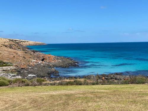 a view of the ocean from a field of grass at Kepals on the Coast - Kangaroo Island in Penneshaw