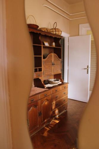 a room with a wooden dresser and a white door at Lovely Nest near Budapest in Dunakeszi