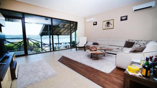 a living room with a couch and a table at Penev guest house in Glavatartsi