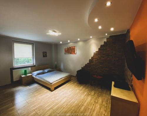 a bedroom with a bed and a stair case at Apartamenty Energo in Bytom