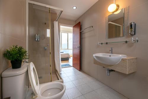 a bathroom with a toilet and a sink at Rex Ollie @ 231 TR Suite in Kuala Lumpur