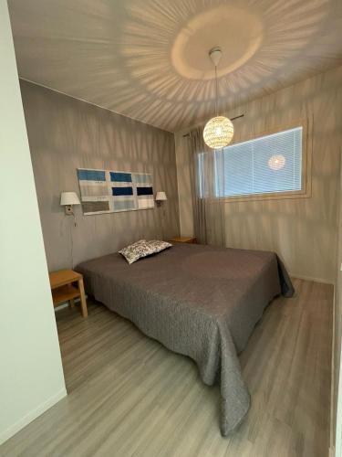 a bedroom with a large bed and a window at Meritähti 205 in Kalajoki