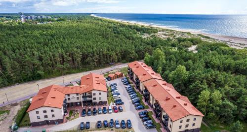 an aerial view of a resort with a parking lot and the beach at Lagūna - Šventoji in Šventoji