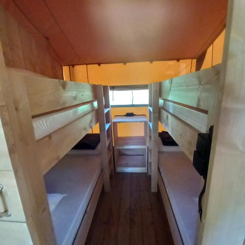 an overhead view of a room with bunk beds at Camping du Moulin de Thoard in Thoard