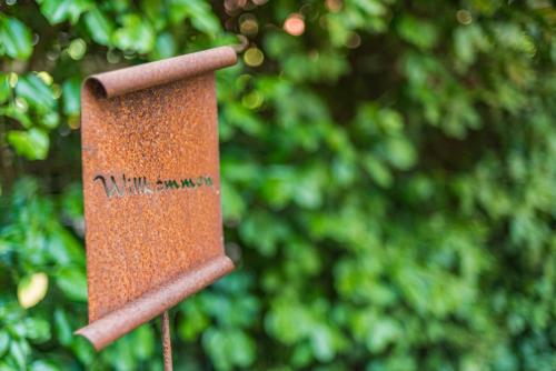 a close up of a rusty object with trees in the background at Romantik Hotel Reichshof in Norden