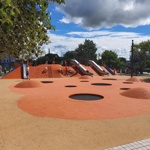 a playground with a slide in a park at Old Town River Apartments in Klaipėda