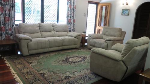 a living room with a couch and two chairs at Arcadia Gardens in Arcadia