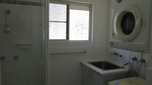 a bathroom with a sink and a shower with a window at Arcadia Beach Unit 4 in Arcadia