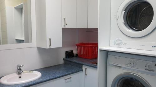 a kitchen with a washing machine and a sink at Magnetic Reef 7 in Arcadia