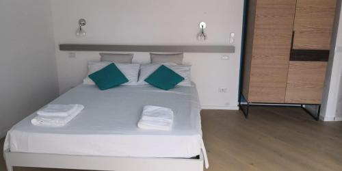 a bed room with a white bedspread and white pillows at B&B La Gaetana in Gaeta