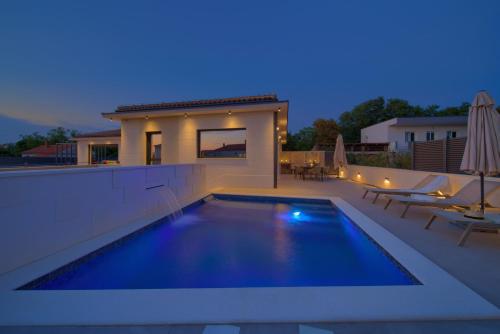 a swimming pool on the roof of a house at Villa QUARNARO with heated pool in Omišalj
