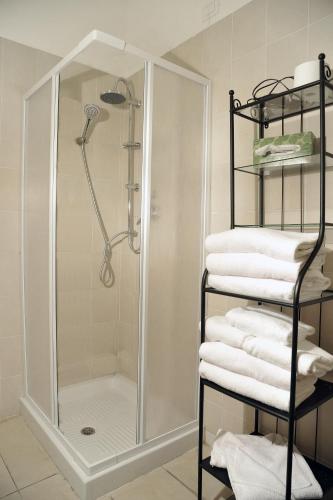a shower in a bathroom with a stack of towels at Locanda al Viminale in Rome