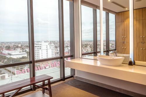 a bathroom with a sink and large windows at KOVIE HOTEL in Ðoan Xá