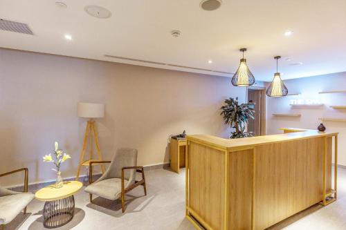a living room with a desk and a table and chairs at KOVIE HOTEL in Ðoan Xá