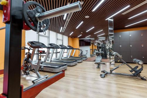 a gym with a row of treadmills and machines at KOVIE HOTEL in Ðoan Xá