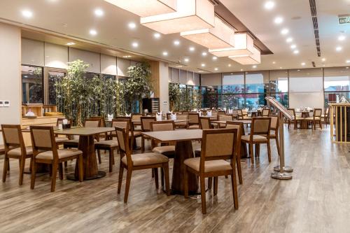 a restaurant with tables and chairs in a building at KOVIE HOTEL in Ðoan Xá