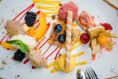 a plate of food with a letter b on it at Romantik Hotel Reichshof in Norden