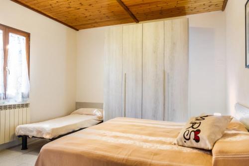 a bedroom with two beds and a window at Perla marina in Grosseto