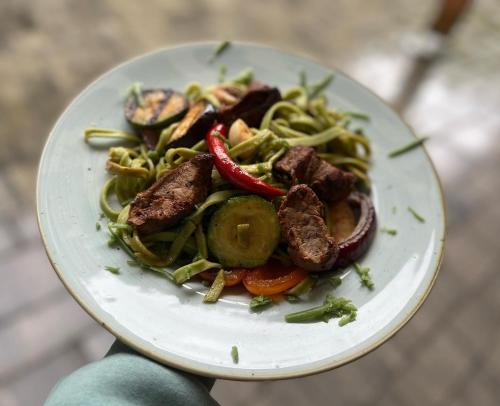 a plate of food with meat and vegetables at Szelesiówka & SPA in Chodzież