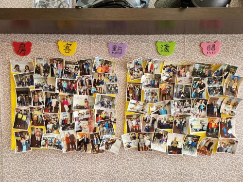 a bunch of pictures on a table with chinese characters at 花蓮阿羅國際青年旅舍民宿 in Hualien City