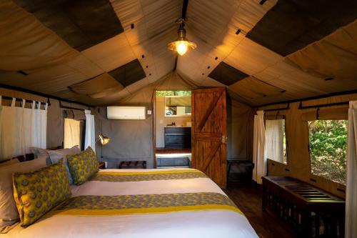 a bedroom with a bed in a tiny house at Ichingo Chobe River Lodge by Mantis in Punga