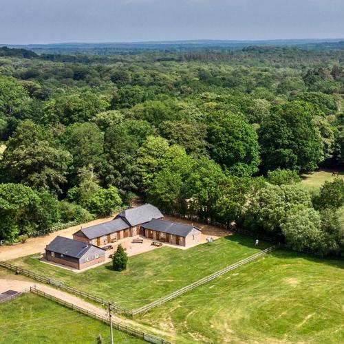 an aerial view of a house in the middle of a field at Mill Lane Farm Holiday Cottages in Lyndhurst