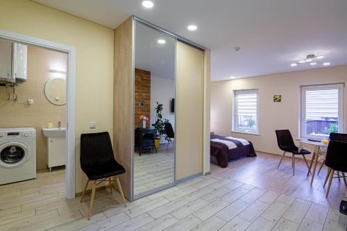 uma sala de estar com um quarto com uma cama e uma cozinha em LIUX apartamentai em Kaunas