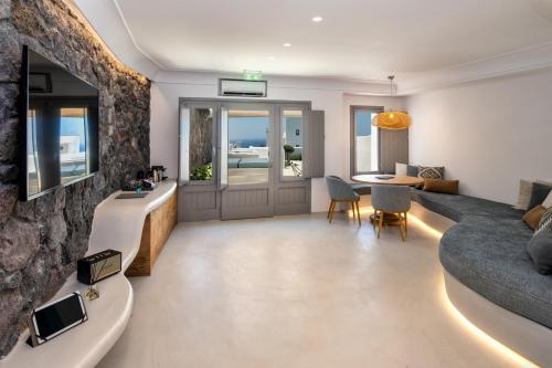 a living room with a couch and a table at La Ponta Villas & Suites in Akrotiri