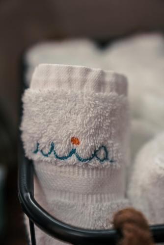 a stack of towels sitting on a rack at Mia Marine Rooms in Himare